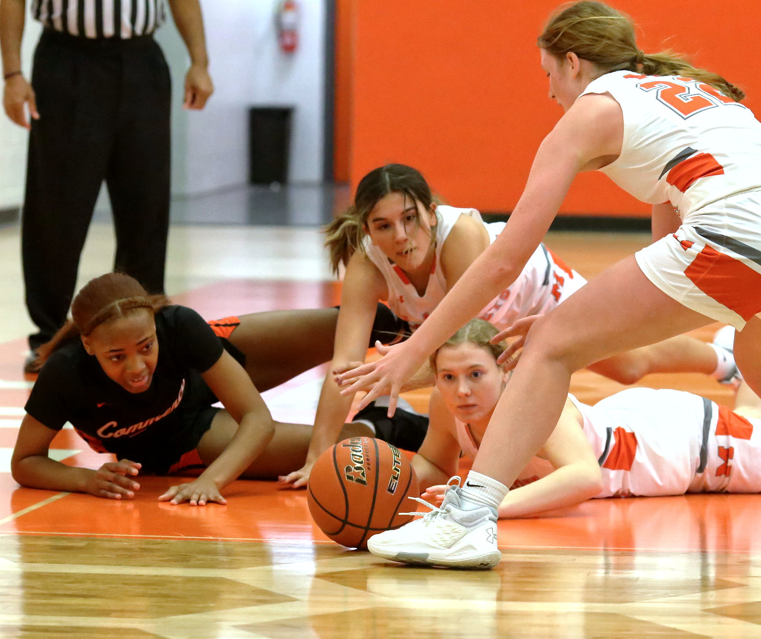 Three Lady Jackets, from left, Carmen Carrasco, Mylee Fischer and Macy Fischer, hustling for a loose ball against one Lady Tiger pretty much sums up Mineola’s signature win last Tuesday against Commerce.
